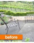 Patio with metal chairs and bench, surrounded by greenery and vineyard in the background.