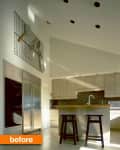 Modern kitchen with beige cabinets, stainless steel fridge, island with stools, and wall-mounted kitchen tools.