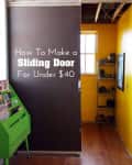 DIY sliding door in a hallway with yellow walls, wooden floor, and green magazine rack.