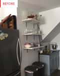 Kitchen corner with stainless steel fridge, open shelves with glass jars, blue cabinet, and two trash bins.
