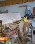 Old sofa in workshop with exposed stuffing and tools, labeled "before."
