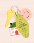 Keychain with a yellow key, house charm, smiley face, and tag reading "The Key to an Accessible Thanksgiving" with a turkey.