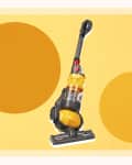 Yellow upright vacuum cleaner with a transparent canister on a yellow background with two large circles.