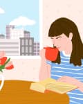 Woman in a striped shirt reading a book at a table with tulips, holding a red mug, cityscape visible through the window.