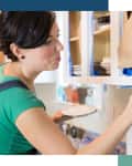 Woman painting cabinets