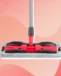 Red and black mop with a gray microfiber pad on a pink abstract background.