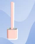 Pink toilet brush with holder on a blue abstract background.