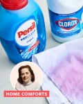 Laundry products with a stained cloth, including Persil detergent, Clorox bleach, and a bowl of water.