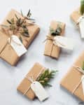 diy gift wrapped presents in brown paper, yarn, and plants