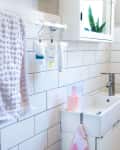 A bathroom with a small, narrow sink.