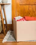 cardboard box filled with clothing in home