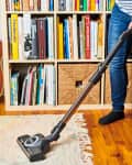 someone vacuuming home rug
