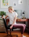 stretching back in chair at home office