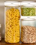 head on shot of the Cliik containers on a kitchen shelf, filled with pasta, lentils and beans