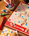 someone playing scrabble with snacks