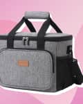 Gray insulated cooler bag with black straps and front pocket on a pink abstract background.