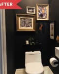 Small bathroom with black walls, white toilet, and sink. Gold-framed art and mirror decorate the walls.