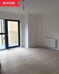 Empty room with light wood flooring, radiator, and large black-framed window.