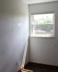 Small empty room with a single window, white walls, and dark floor, labeled "Before" in the top left corner.
