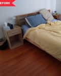 Unmade bed with yellow duvet, blue and beige pillows, wooden headboard, and bedside table with tissue box.