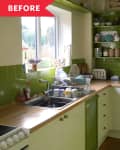 Small kitchen with green tile backsplash, wooden countertops, dish rack, toaster, and jars on shelves.