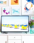 white room with tv and gallery wall