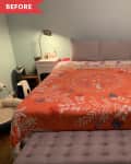 Bedroom with orange floral bedspread, gray tufted bench, white nightstands, and light blue walls.