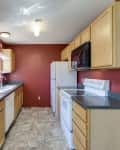 Before: Galley kitchen with red walls and yellowy oak cabinets