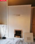 Before: Living space with white and brown walls