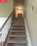 Before: Dim brown-carpeted stairs