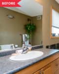 Before: Tan bathroom with white tub and wood vanity