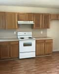 Before: beige kitchen with dark wood cabinets