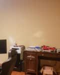 Before: cluttered office with beige walls