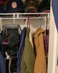 Before: crowded closet full of coats and hats