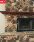 Before: Dated fireplace with dark mismatched stone