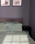 Before: Bedroom with dark gray-purple walls and black nightstands