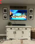 Before: TV above a white farmhouse-style sideboard