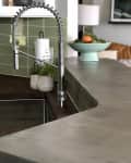 Island countertop with feathered concrete finish in gray color.