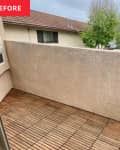 Before: empty balcony with wood floor and stucco walls