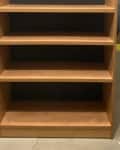 Before: plain wood shelf in a garage setting