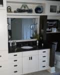 Before: Bathroom with white cabinetry and shelving