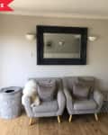 Before: Plain wall with two arm chairs in front, plus a mirror mounted on the wall