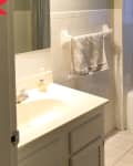 Before: bathroom with white square tile on floors and walls