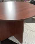 Before: Round laminate table with a shiny red-toned wood finish