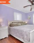 Lavender bedroom with white bed, green pillows, ceiling fan, and wooden floor. White nightstand and wardrobe.