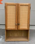 Before: plain wood cabinet with two doors and an open shelf on the bottom