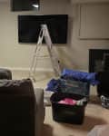 Before: Cluttered basement with beige walls and carpet