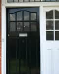 Before: Brick house with black door
