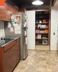 Before: Kitchen with brown floors and brown cabinets