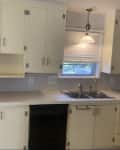 Before: Yellowish cabinetry in kitchen